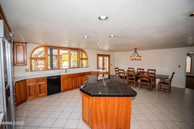 9100 Wigwam Way, Reno, NV 89506 - kitchen featuring black appliances, light tile patterned flooring, recessed lighting, a center island, and brown cabinetry