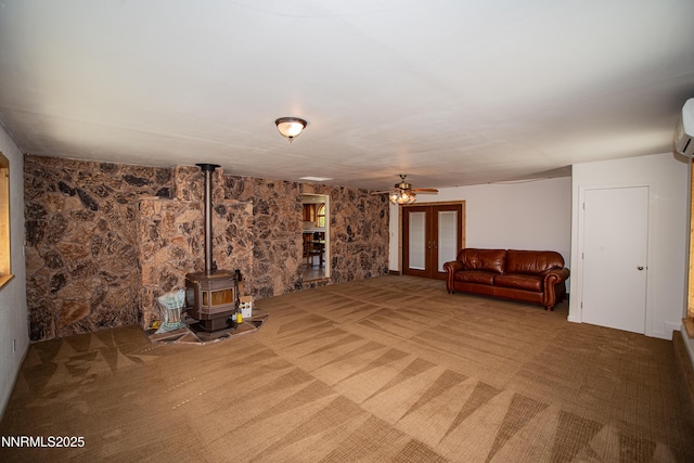 9100 Wigwam Way, Reno, NV 89506 - unfurnished living room with a wood stove, carpet floors, and a ceiling fan