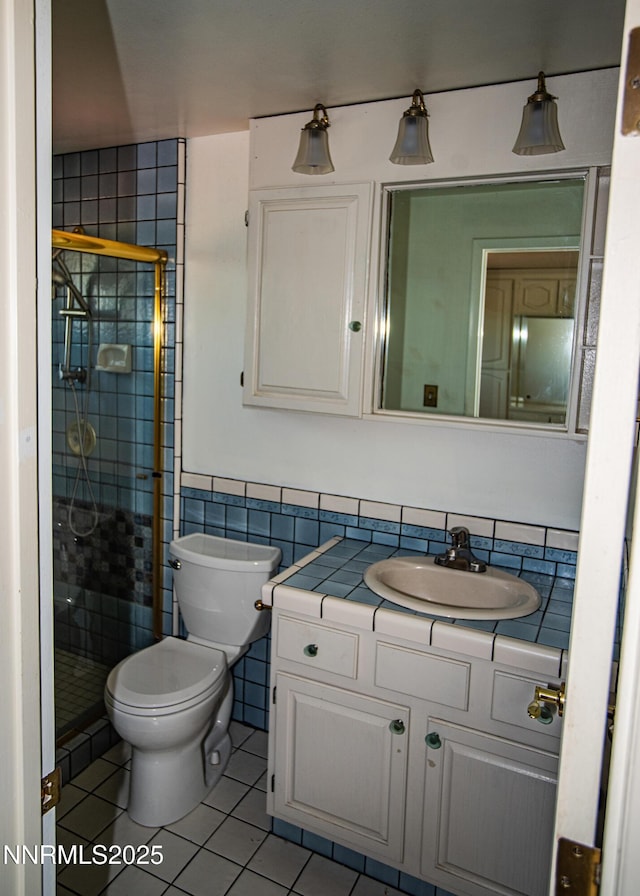 9100 Wigwam Way, Reno, NV 89506 - bathroom with tile patterned flooring, a stall shower, toilet, tile walls, and vanity