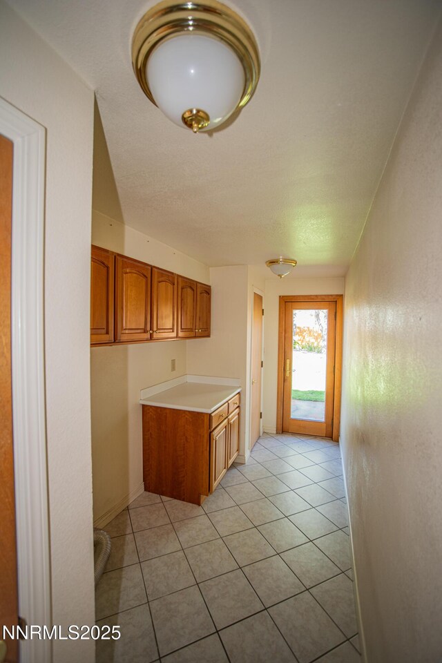 9100 Wigwam Way, Reno, NV 89506 - kitchen with brown cabinetry, light countertops, and light tile patterned floors