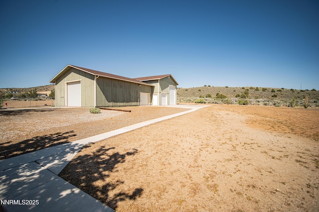 9100 Wigwam Way, Reno, NV 89506 - view of front facade with an outbuilding, a detached garage, and board and batten siding