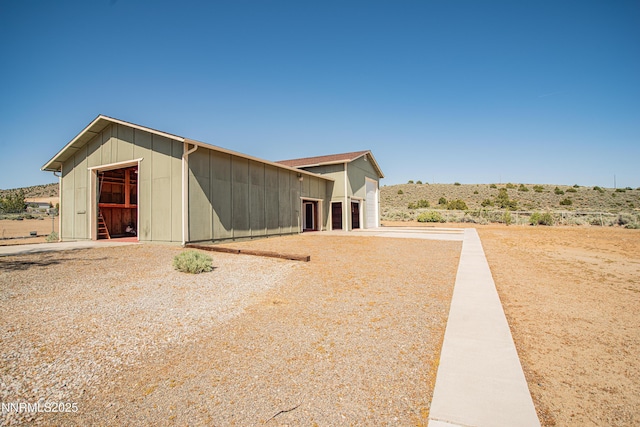 9100 Wigwam Way, Reno, NV 89506 - view of property exterior with board and batten siding and an attached garage