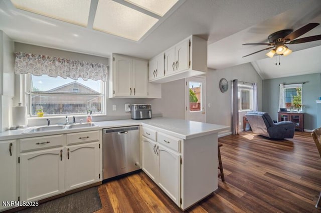 1061 Aimee Ln, Fallon, NV 89406 - kitchen with stainless steel dishwasher, a peninsula, open floor plan, dark wood finished floors, and a sink