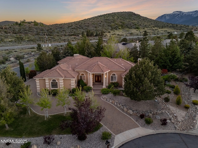 14501 Quail Rock Ct, Reno, NV 89511 - view of front of home with stucco siding, a tiled roof, and a mountain view