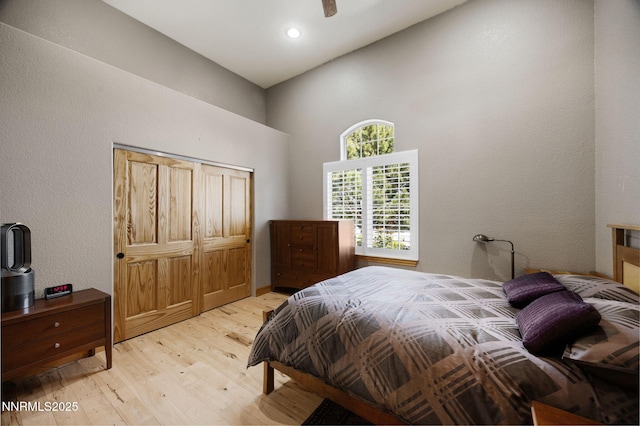 14501 Quail Rock Ct, Reno, NV 89511 - bedroom with light wood finished floors, a towering ceiling, a closet, and recessed lighting