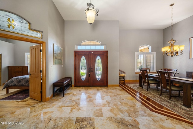 14501 Quail Rock Ct, Reno, NV 89511 - foyer entrance featuring a chandelier, baseboards, and a towering ceiling