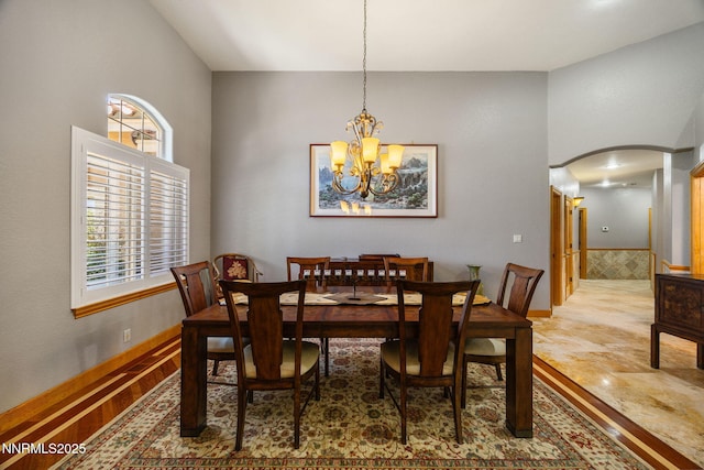 14501 Quail Rock Ct, Reno, NV 89511 - dining room featuring arched walkways and a chandelier
