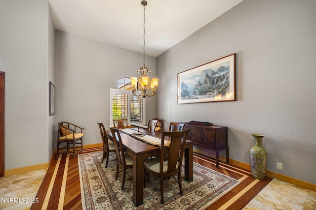 14501 Quail Rock Ct, Reno, NV 89511 - dining area featuring a chandelier, light wood-style flooring, and baseboards