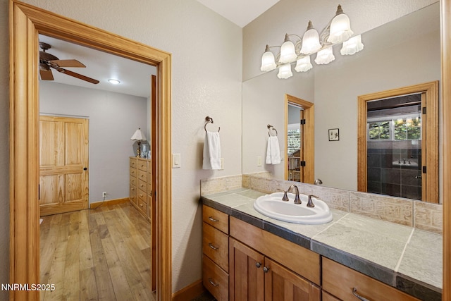 14501 Quail Rock Ct, Reno, NV 89511 - bathroom with wood-type flooring, vanity, a ceiling fan, and baseboards