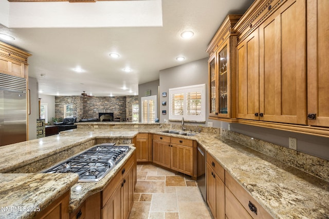 14501 Quail Rock Ct, Reno, NV 89511 - kitchen with a sink, appliances with stainless steel finishes, stone tile flooring, light stone counters, and open floor plan