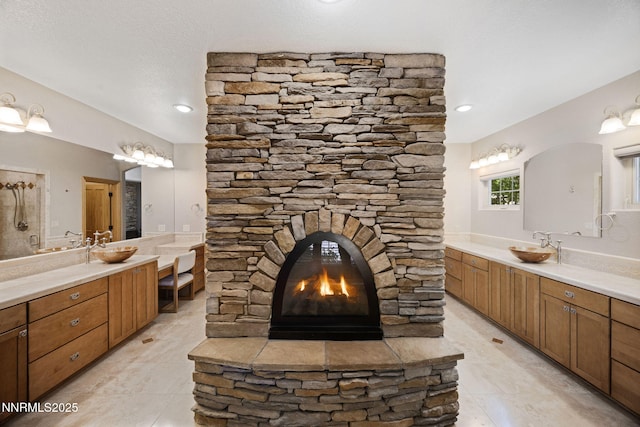 14501 Quail Rock Ct, Reno, NV 89511 - bathroom with two vanities, a stone fireplace, and tile patterned floors