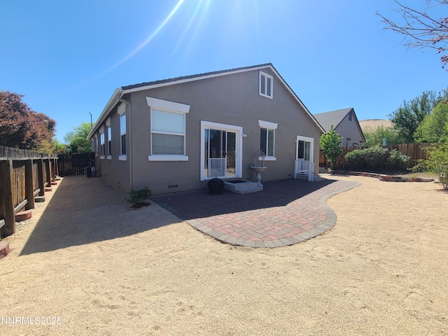 580 Boulder Peak Ct, Sparks, NV 89436 - rear view of house featuring a fenced backyard, a patio area, stucco siding, and crawl space