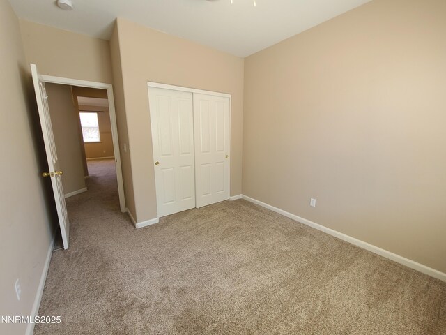 580 Boulder Peak Ct, Sparks, NV 89436 - unfurnished bedroom featuring carpet, a closet, and baseboards