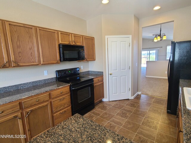 580 Boulder Peak Ct, Sparks, NV 89436 - kitchen featuring black appliances, brown cabinets, recessed lighting, baseboards, and dark stone countertops
