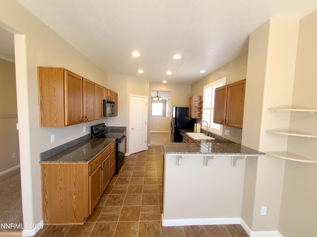 580 Boulder Peak Ct, Sparks, NV 89436 - kitchen featuring black appliances, open shelves, a breakfast bar area, recessed lighting, and a sink