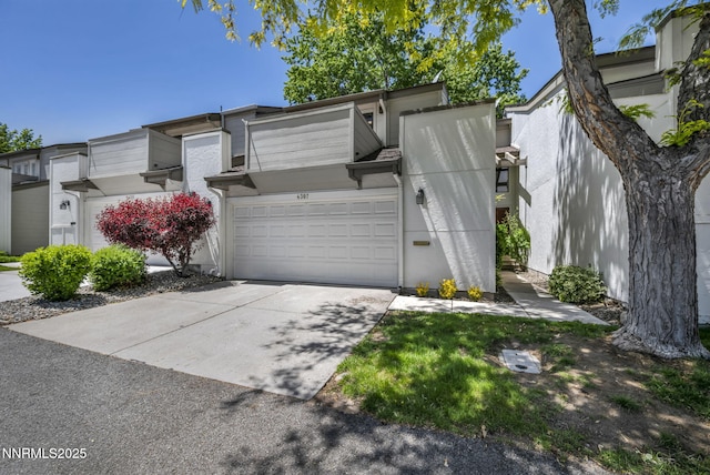 4307 Clyde Ct, Reno, NV 89509 - view of front of property featuring driveway, stucco siding, and a garage