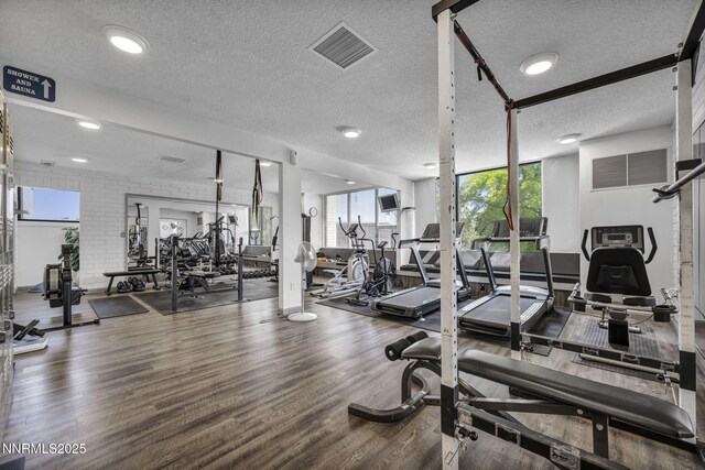 4307 Clyde Ct, Reno, NV 89509 - exercise room featuring a textured ceiling and wood finished floors