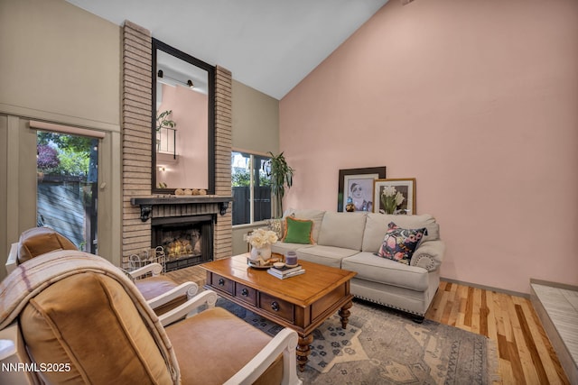 4307 Clyde Ct, Reno, NV 89509 - living room with high vaulted ceiling, a brick fireplace, wood finished floors, healthy amount of natural light, and baseboards