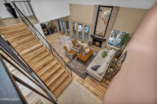 4307 Clyde Ct, Reno, NV 89509 - living room with stairway, a fireplace, a towering ceiling, and tile patterned floors