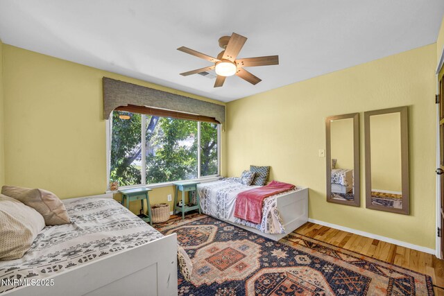 4307 Clyde Ct, Reno, NV 89509 - bedroom with wood finished floors, baseboards, and a ceiling fan