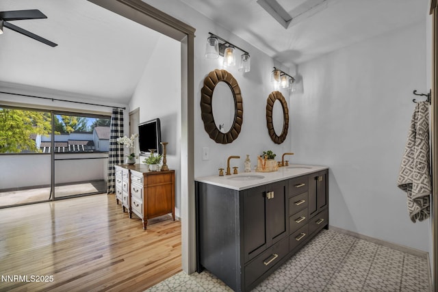 4307 Clyde Ct, Reno, NV 89509 - bathroom featuring double vanity, a ceiling fan, vaulted ceiling, and baseboards