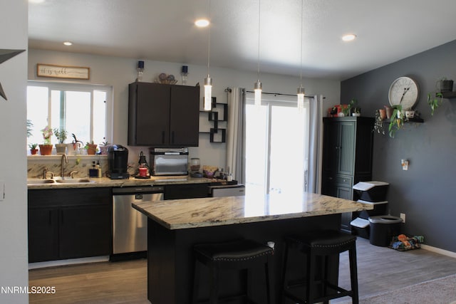 1311 Yellowjacket Ln, Gardnerville, NV 89460 - kitchen with stainless steel dishwasher, a sink, wood finished floors, plenty of natural light, and recessed lighting