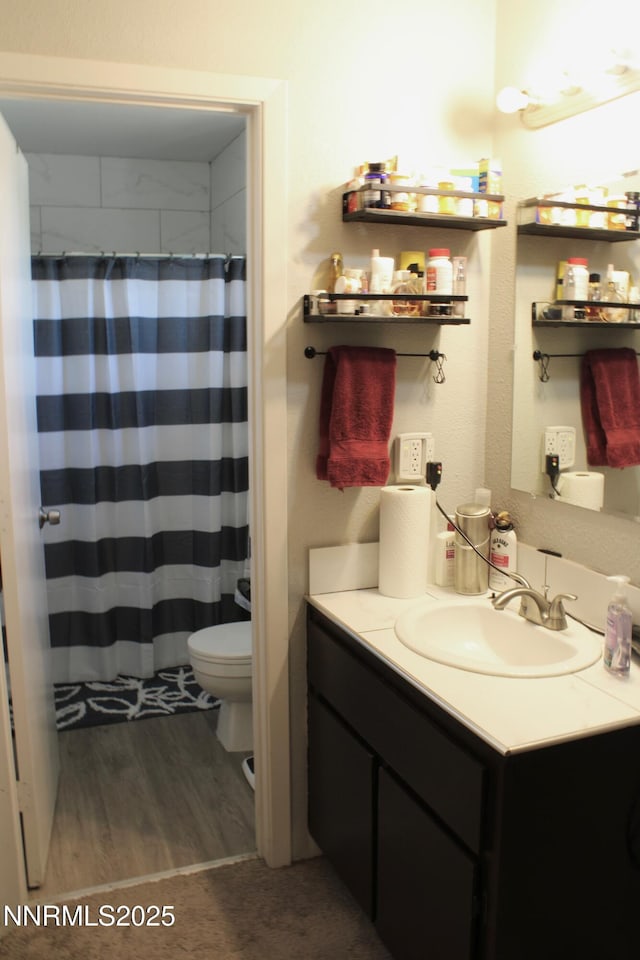 1311 Yellowjacket Ln, Gardnerville, NV 89460 - full bathroom with toilet, wood finished floors, vanity, and a shower with curtain