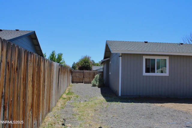 1311 Yellowjacket Ln, Gardnerville, NV 89460 - view of side of home featuring a fenced backyard and roof with shingles