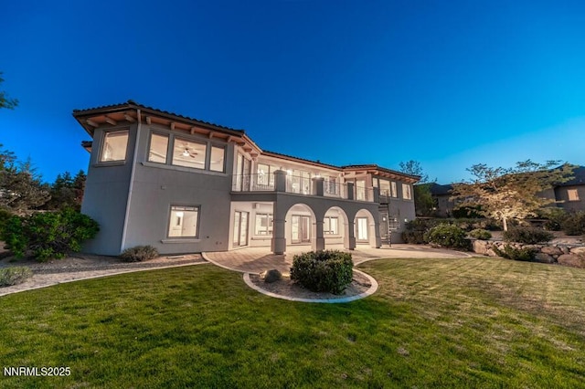 14200 Wild Quail Ct, Reno, NV 89511 - mediterranean / spanish home with a balcony, a front lawn, stucco siding, a patio, and a tiled roof