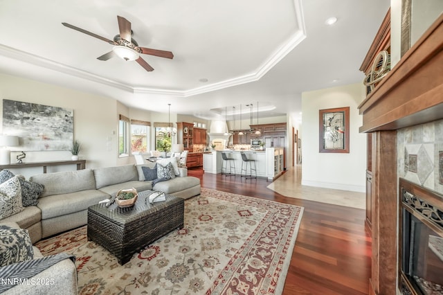 14200 Wild Quail Ct, Reno, NV 89511 - living room featuring a tray ceiling, a fireplace, ceiling fan, wood finished floors, and baseboards