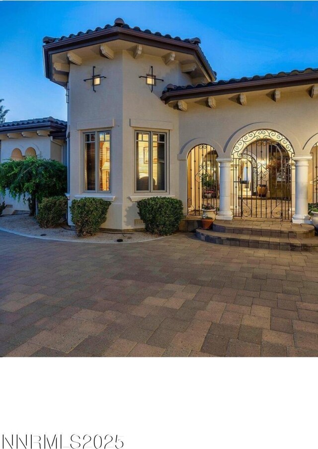 14200 Wild Quail Ct, Reno, NV 89511 - back of property featuring a tiled roof and stucco siding