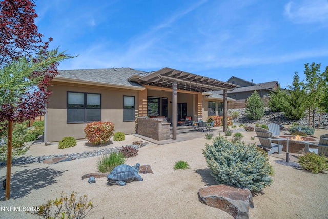4069 Whispering Pine Loop, Reno, NV 89519 - back of house featuring a fire pit, stucco siding, a patio area, a shingled roof, and a pergola