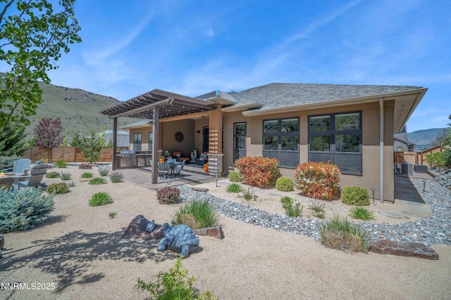4069 Whispering Pine Loop, Reno, NV 89519 - back of property with a pergola, stucco siding, a patio area, and a mountain view