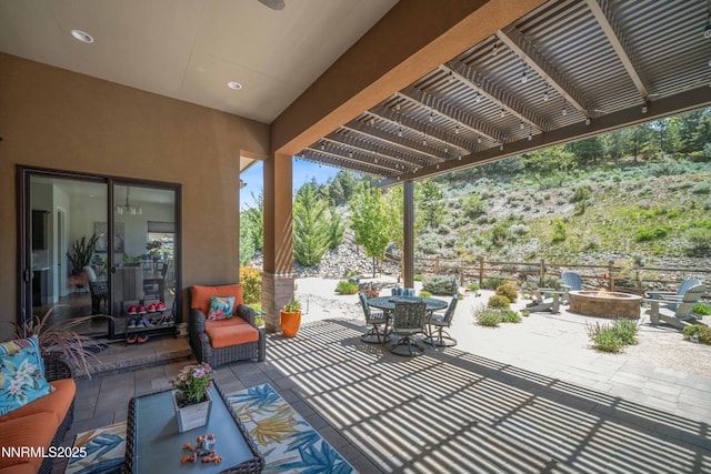 4069 Whispering Pine Loop, Reno, NV 89519 - view of patio with a fire pit, outdoor dining area, and a pergola