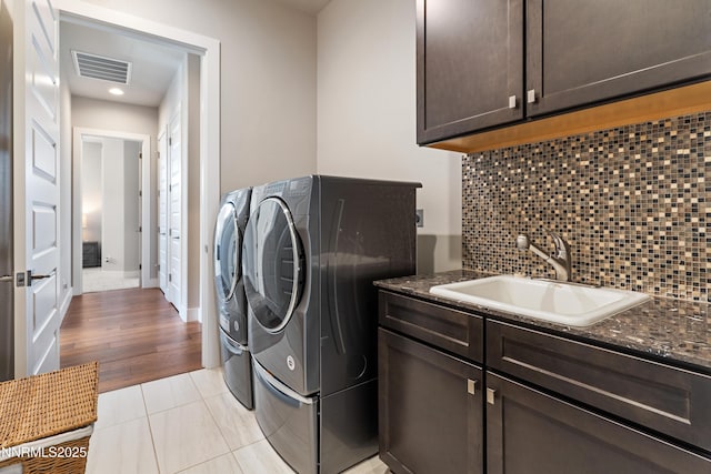 4069 Whispering Pine Loop, Reno, NV 89519 - laundry room featuring washing machine and dryer, cabinet space, recessed lighting, light tile patterned flooring, and baseboards