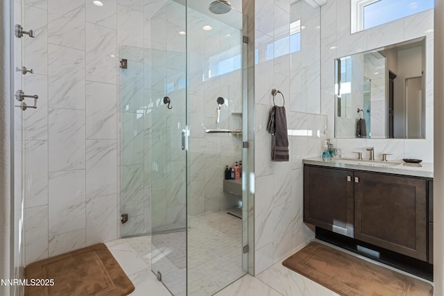 4069 Whispering Pine Loop, Reno, NV 89519 - bathroom featuring marble look tiles, a marble finish shower, vanity, and tile walls