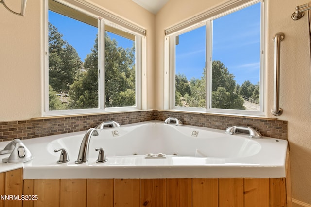 2140 Conestoga Rd, Reno, NV 89521 - bathroom featuring plenty of natural light, a tub with jets, and decorative backsplash