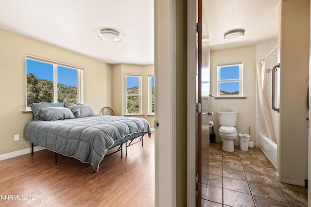2140 Conestoga Rd, Reno, NV 89521 - bedroom featuring multiple windows, a textured ceiling, and baseboards