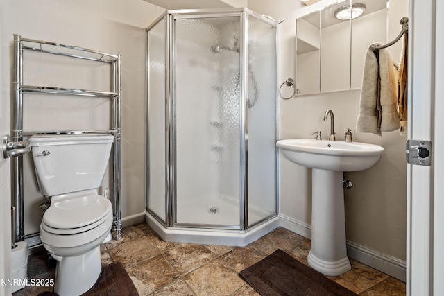 2140 Conestoga Rd, Reno, NV 89521 - bathroom featuring a stall shower, toilet, and baseboards