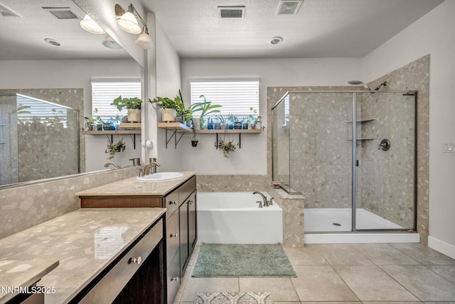 2028 Whitecliff Dr, Reno, NV 89521 - bathroom featuring vanity, a garden tub, a shower stall, healthy amount of natural light, and a textured ceiling