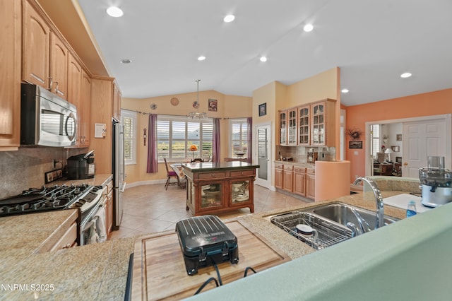 1184 Stephanie Way, Minden, NV 89423 - kitchen featuring appliances with stainless steel finishes, a sink, backsplash, lofted ceiling, and glass insert cabinets