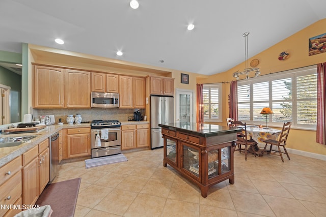1184 Stephanie Way, Minden, NV 89423 - kitchen featuring appliances with stainless steel finishes, lofted ceiling, light brown cabinetry, decorative backsplash, and recessed lighting