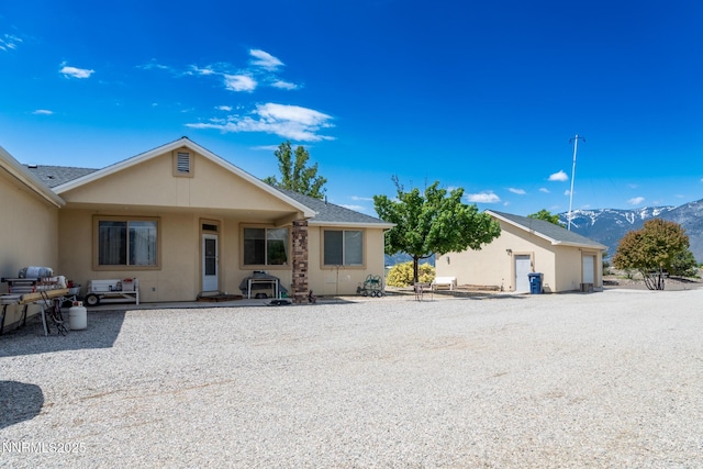 1184 Stephanie Way, Minden, NV 89423 - rear view of house with a mountain view, stucco siding, and roof with shingles