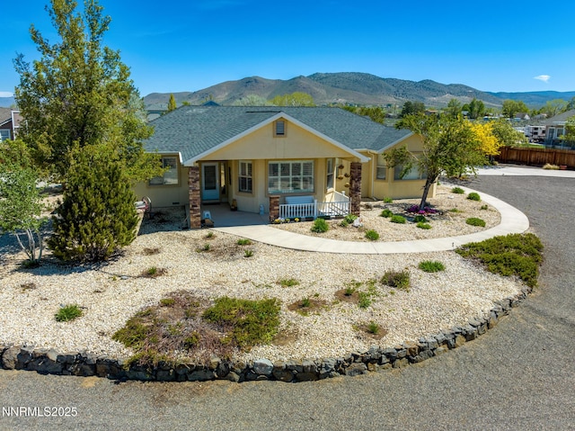 1184 Stephanie Way, Minden, NV 89423 - view of front of home featuring covered porch, a mountain view, stucco siding, and a shingled roof