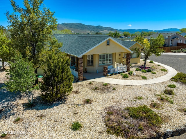 1184 Stephanie Way, Minden, NV 89423 - view of front of house with a mountain view, stucco siding, covered porch, and a shingled roof