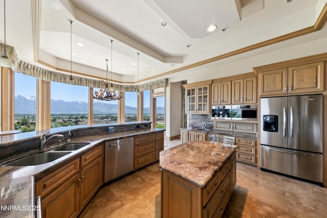 1103 Cortez Ln, Gardnerville, NV 89410 - kitchen with stainless steel appliances, a raised ceiling, brown cabinets, a mountain view, and recessed lighting