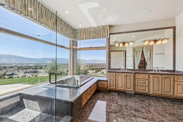 1103 Cortez Ln, Gardnerville, NV 89410 - bathroom with double vanity, a mountain view, marble tiled flooring, a bath, and recessed lighting