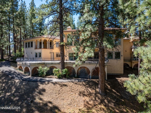 390 Sylvan Ct, Verdi, NV 89439 - rear view of property with a balcony, a chimney, and stucco siding