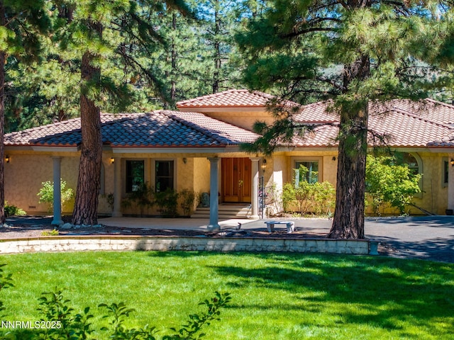 390 Sylvan Ct, Verdi, NV 89439 - mediterranean / spanish-style home with stucco siding, a front yard, a tiled roof, and covered porch