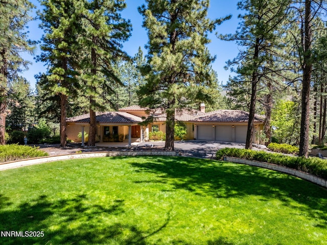 390 Sylvan Ct, Verdi, NV 89439 - view of front facade with a tile roof, a garage, a front yard, and concrete driveway